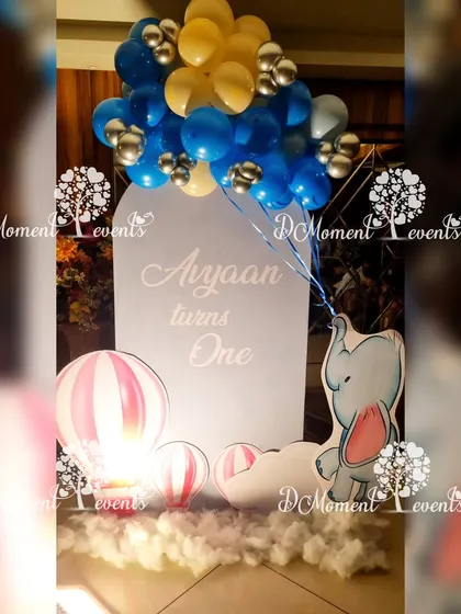 A cute elephant and hot air balloon prop for a space-themed first birthday, adding a touch of whimsy to the decor.