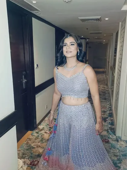 A full look of the client with her retro Hollywood waves, pairing perfectly with her shimmery lehenga for a sangeet night.