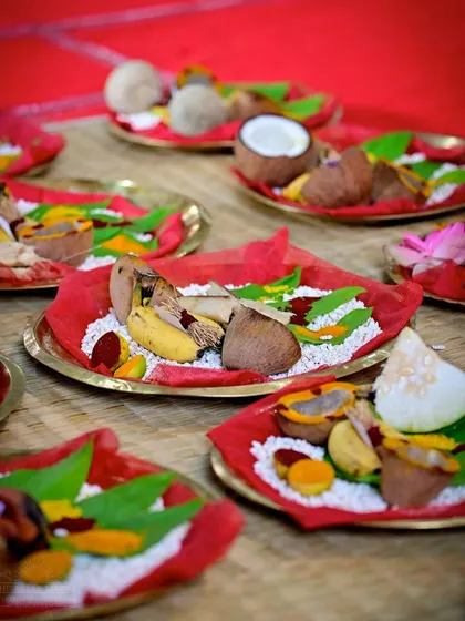 Plates of offerings prepared for the Shat Chandi Homa. Each offering, from coconuts to fruits, is arranged with care and devotion.