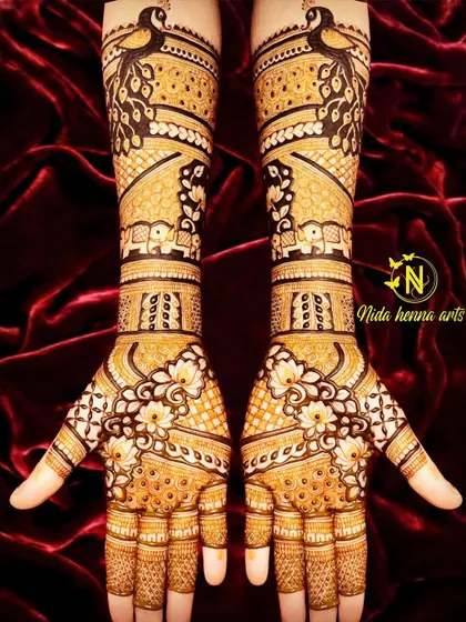 This Indian design starts with a beautiful peacock at the top of the arm. The pattern flows down to include small elephant figures and floral jaal work on the palms.