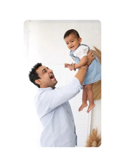 A father joyfully lifts his baby into the air. These dynamic, action-filled shots add a sense of fun and energy to your family gallery.