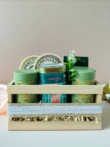 A straight-on view of our wooden tray hamper, highlighting its clean lines and the elegant arrangement of green-themed gift items inside.