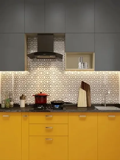 A compact straight kitchen with a pop of color. The bright yellow lower cabinets are balanced by neutral grey uppers and a patterned backsplash, creating a fun and functional cooking area.