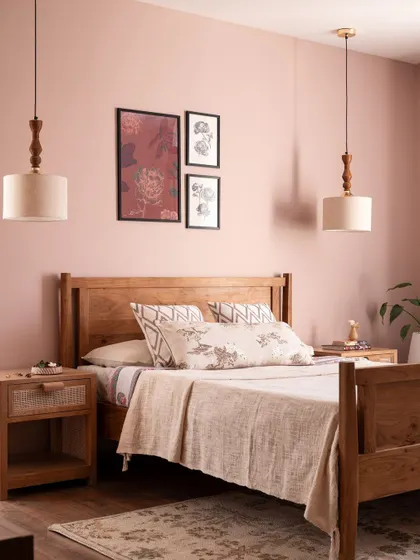 The parents' bedroom in the Aqua Home is wrapped in a dusty rose tone for a warm, feminine energy. The simple wood bed frame and nightstands keep the focus on the beautiful color.