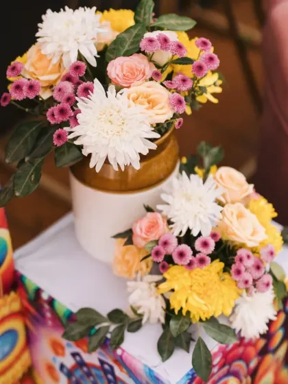 A top-down view of the rustic floral arrangements, highlighting the fresh and colorful blooms used to brighten the Mehendi event.