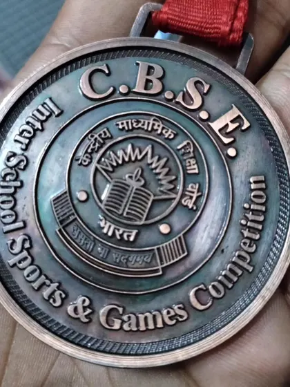 A close-up of the C.B.S.E. Inter-School Sports & Games Competition bronze medal.