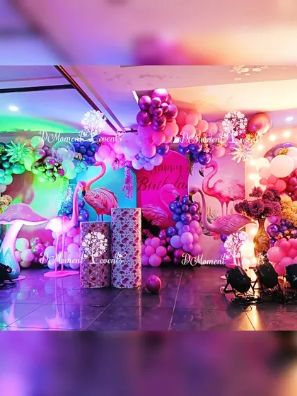 A vibrant and tropical flamingo-themed party, using dramatic lighting, lush balloon arrangements, and flamingo props to create a fun party atmosphere.