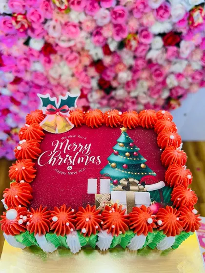 A still image of the square Christmas cake, showing the edible holiday print and festive decorations.
