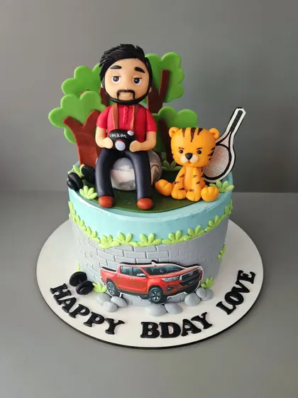 Make your man's birthday extra special with a customized cake. This chocolate truffle cake features a photographer with his camera, a tiger, and his Toyota Hilux.
