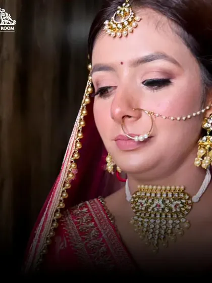 A soft and romantic bridal look. The focus here is on natural-looking skin, subtly defined eyes, and traditional jewellery like the nath and tikka.