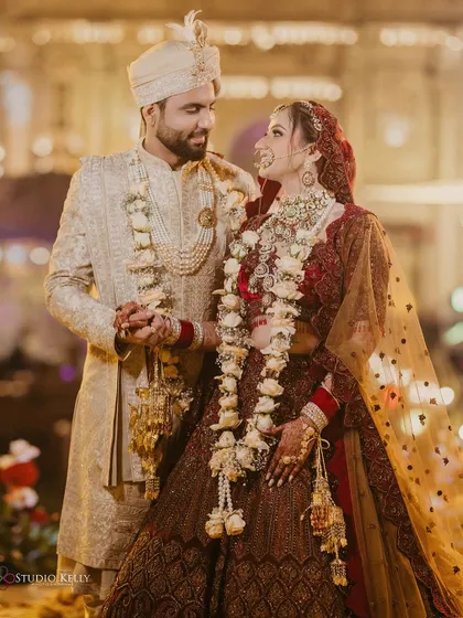 A happy and classic portrait of the couple, smiling at each other after their wedding ceremony.