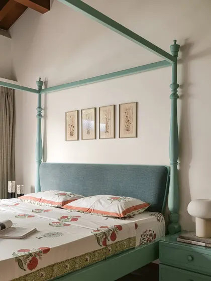 This bedroom in Kolam Pop is a joyful play of form and color. A mint-green four-poster bed provides a dramatic focal point, complemented by hand-block printed linens.