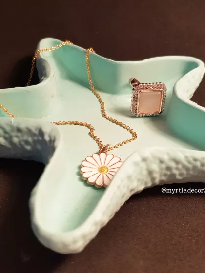 The starfish trinket tray in a lovely teal color. It’s a wonderful piece for adding a pop of coastal-inspired color to your room.