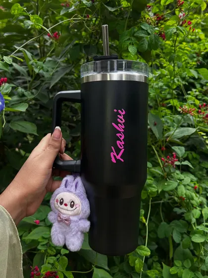 A personalized black tumbler with a cute Labubu keychain, the perfect trendy gift for a stylish sister or friend.