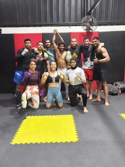 Another shot of the team celebrating our new champion. This moment captures the spirit of Ace MMA, where every individual's success is a victory for the entire team.