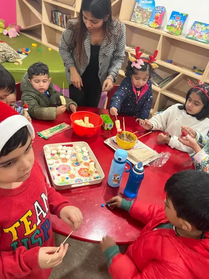 Making delicious and fun Christmas-themed snacks. The kids are putting together fruit skewers, a healthy and festive treat.