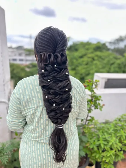 The full view of the stunning, sculptural braid, perfect for a hairstyling competition or a high-fashion bridal look.