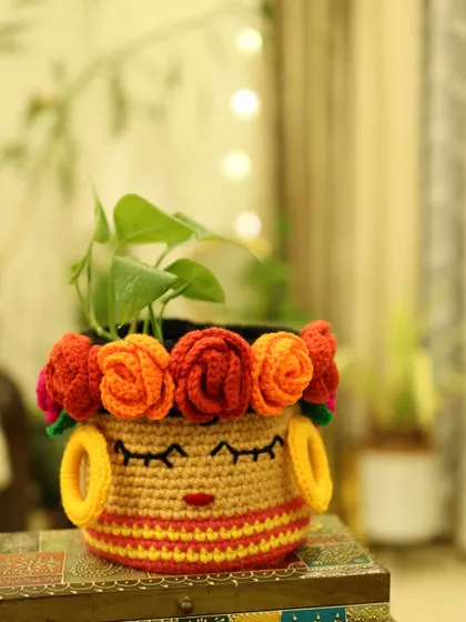My bold and beautiful Frida-inspired basket, featuring a crown of colourful crochet roses and embroidered details. It's a piece of art that doubles as a planter cover or a unique storage basket.