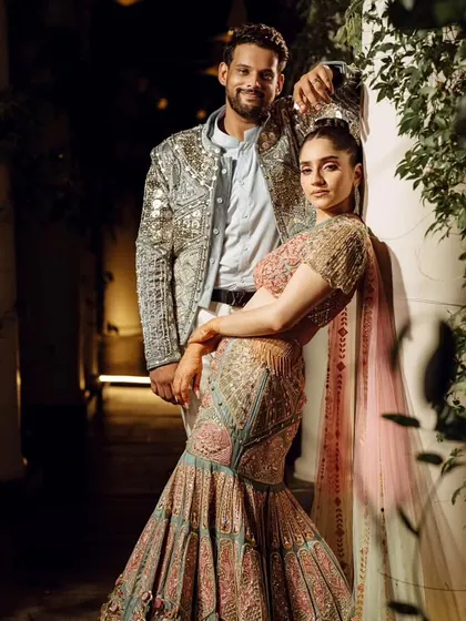 A stylish portrait of the couple in their vibrant Sangeet outfits, showcasing their fun and fashionable personalities.