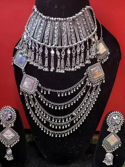 A layered oxidised silver necklace set with square-shaped colorful stones, perfect for a bohemian look.