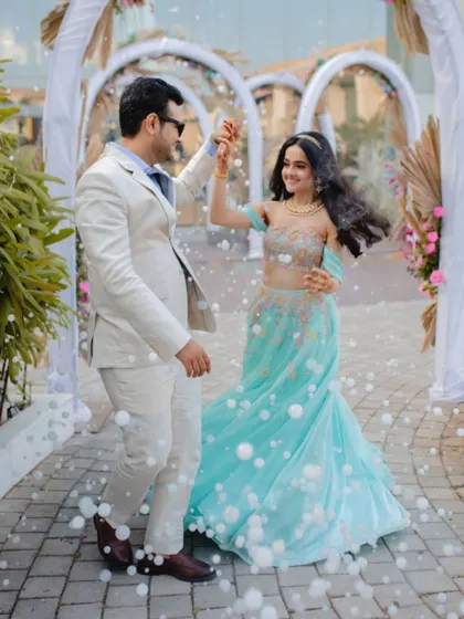 A happy couple dances amidst a shower of bubbles at their pre-wedding carnival, a fun and joyous event I designed to kick off the celebrations.