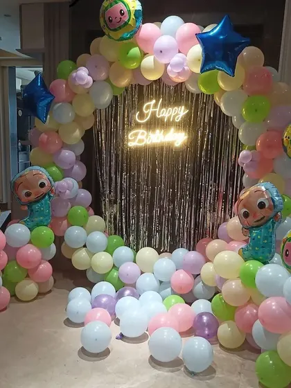 A complete view of the Cocomelon party corner, ready for photos and cake cutting. The setup is bright, cheerful, and perfect for a first birthday.
