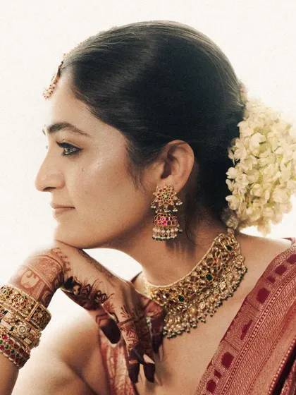 A profile portrait showcasing the bride's serene expression and the beautiful details of her jewelry and hairstyle. The soft, bright light gives this image an ethereal quality.