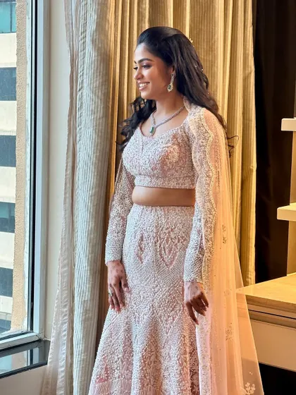 A profile view showcasing the elegant hairstyle and how the makeup complements it perfectly for a complete sangeet-ready look.