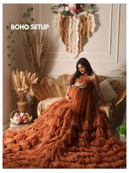 A beautiful example of my boho setup, featuring a stunning ruffled gown in a rich, earthy brown color. The rattan sofa and macrame wall hanging complete the look.