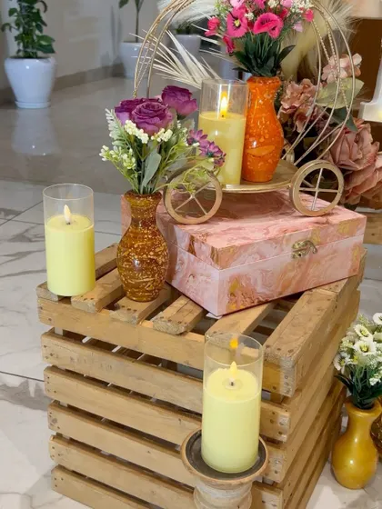 Rustic decor details for a baby shower, including wooden crates, candles, and small floral arrangements.