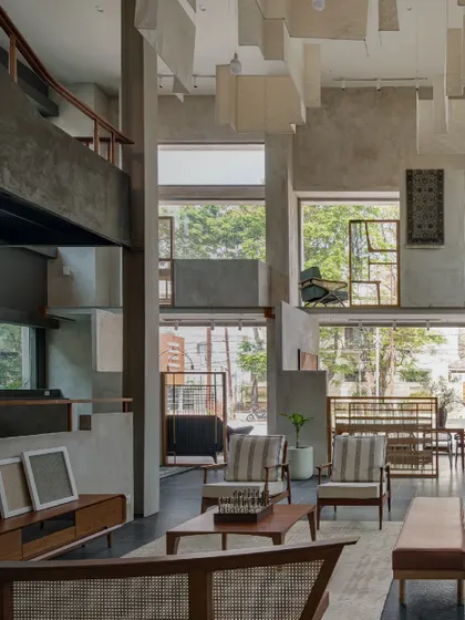 The interior of 'The Earth' is a double-height space defined by raw concrete and large windows that flood the area with natural light. This award-winning design exemplifies our commitment to pioneering creative innovation.