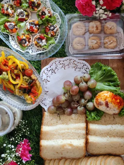 A leisurely breakfast spread perfect for a special morning, including sandwiches, fruit, cheese, and bite-sized appetizers like our Mexican tarts.