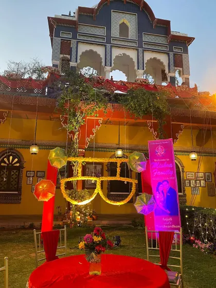 Fun and quirky decor for a sangeet or mehendi, featuring a large, lit-up pair of sunglasses as a central prop.