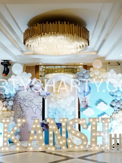 The main stage for the travel and teddy bear theme, with world map backdrops, cloud-like balloons, and large marquee letters.