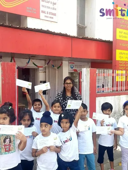 The group poses for a photo outside the H.A.L. Stage II Post Office, holding the letters they are about to mail.