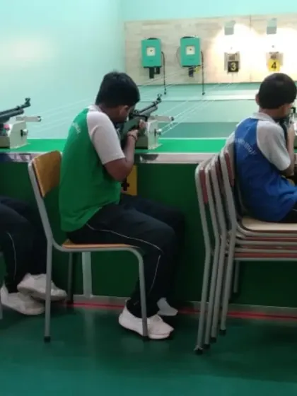Students at our partner school, Greenwoods High, line up for their turn at the range. We make professional shooting training accessible through our extensive school programs.
