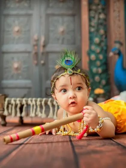 A tummy-time pose for the little Krishna, perfect for capturing the 3-4 month milestone.
