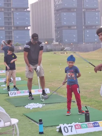 A father and son practice side by side on the range. My facility is designed for families to learn and enjoy the game of golf together.