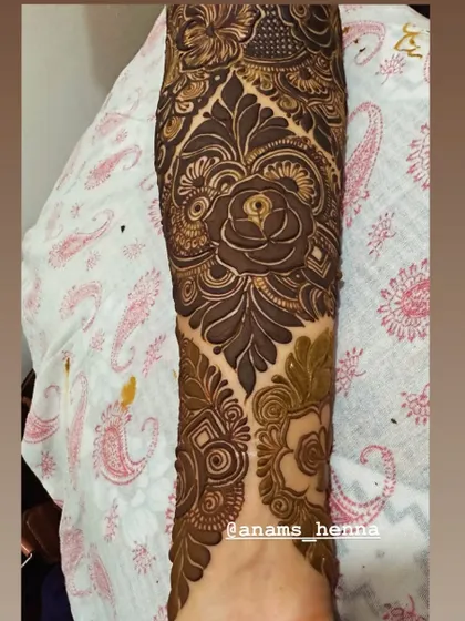 I love using roses as a central element in my bridal designs. Here, a large, shaded rose on the forearm is surrounded by intricate patterns, creating a romantic and classic bridal look.