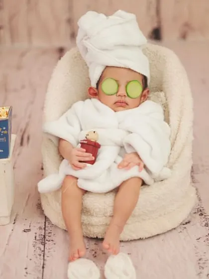 This little client is enjoying a moment of zen. The attention to detail, from the tiny drink to the alarm clock, makes these photos so special.