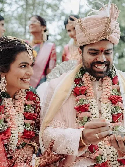 A candid moment of shared smiles between the bride and groom during their ceremony. Their genuine expressions show the comfort and happiness they find in each other's presence.