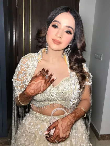 A side profile showing the beautiful curls and mehendi design.