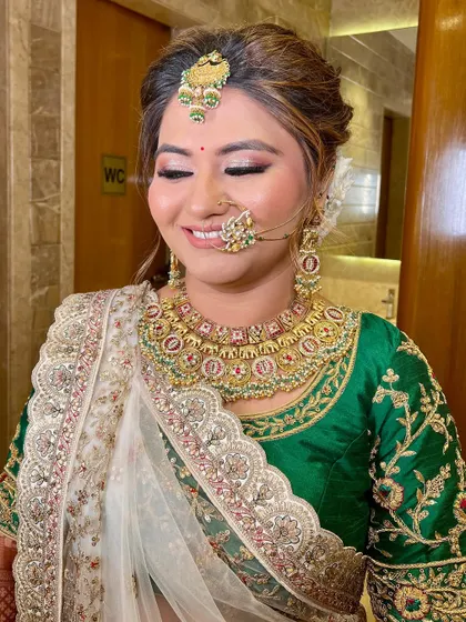 A smiling bride with her eyes closed, showing off the perfectly blended eyeshadow.