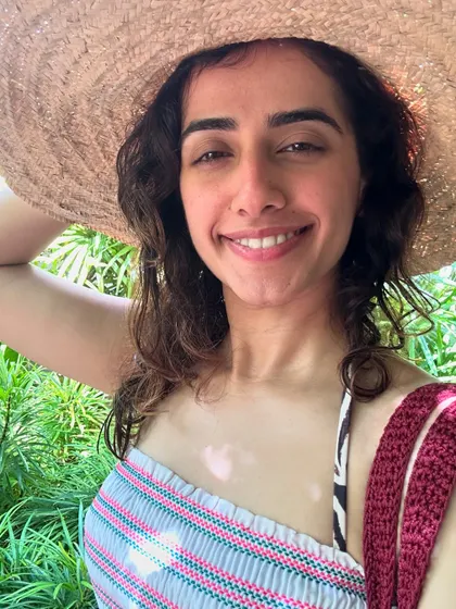 A happy selfie in the tropical sun. The warmth of the island, the lush greenery, and the salty air are a perfect recipe for joy and relaxation.