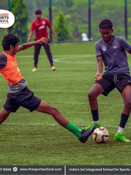 An intense moment as one player makes a decisive tackle to win the ball, a key defensive skill we practice relentlessly.