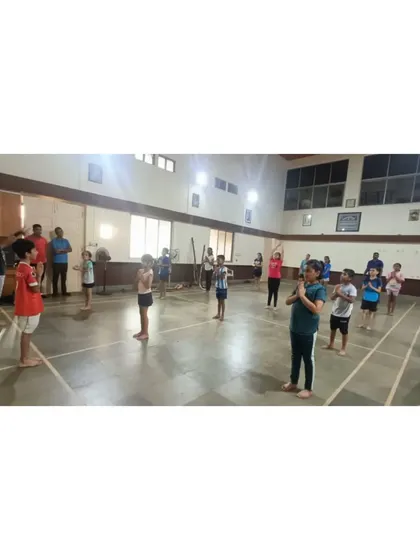 Our students and coaches coming together for a moment of calm during the yoga day event. Building a strong community is as important as building strong players.