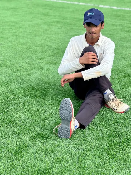 A young cricketer sits for a stretch on the turf. Our fitness sessions are designed to be age-appropriate, building a strong athletic foundation for a long career in the sport.