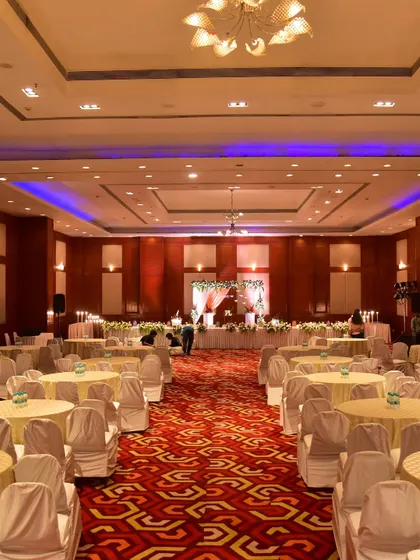 A full view of a Sangeet hall, showing the stage, seating arrangement, and overall ambiance we create for a night of celebration.