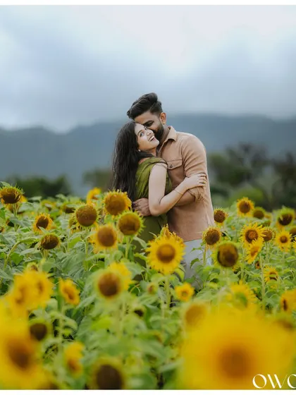 A tender moment shared between a couple in a sunflower field, perfect for a romantic save-the-date announcement.