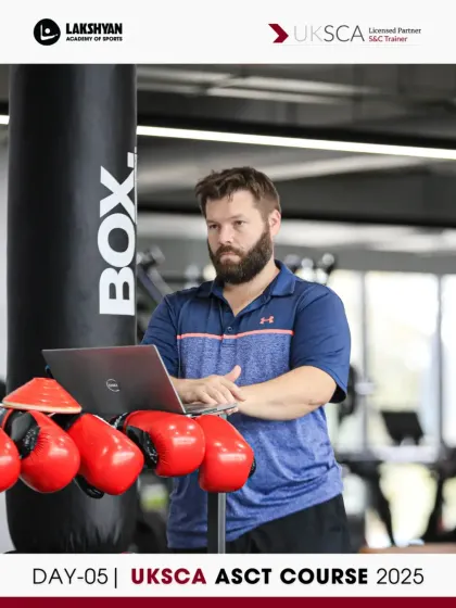 A UKSCA trainer observes a practical session near the boxing equipment, highlighting the diverse athletic contexts our S&C principles apply to.